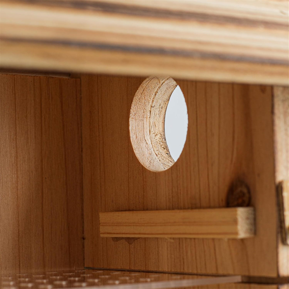 Weatherproof wooden bluebird house side view with round entrance hole under roof overhang
