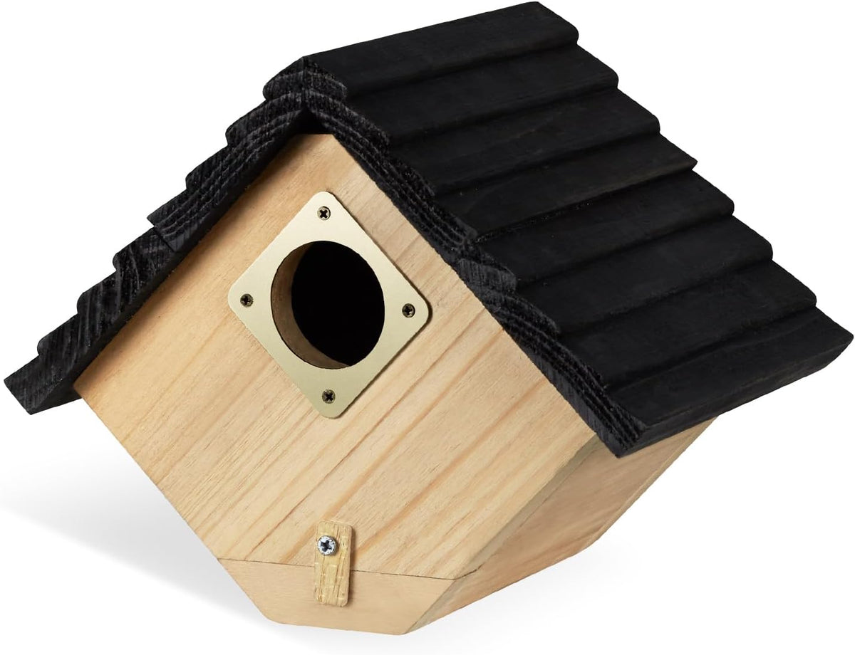 Wooden bird house with black shingled roof, round entrance hole, and latch door